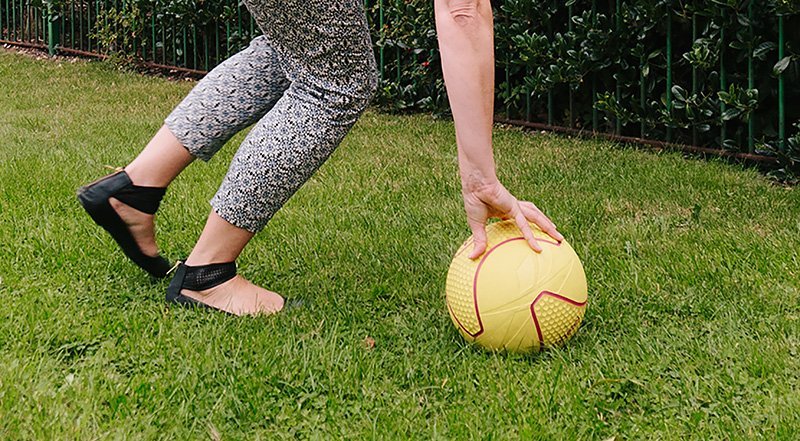 A person takes part in a science experiment to experience space disorientation on earth using a football.