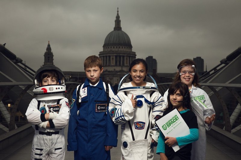 Young astronauts, flight crew and space scientists, wearing special Destination Space space suits or lab gear, ready to join Tim Peake's crew