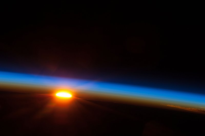 A sunrise over the horizon of the earth from the viewpoint of the International Space Station.
